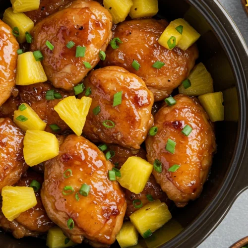 Sweet Hawaiian crockpot chicken with pineapple chunks in a bowl