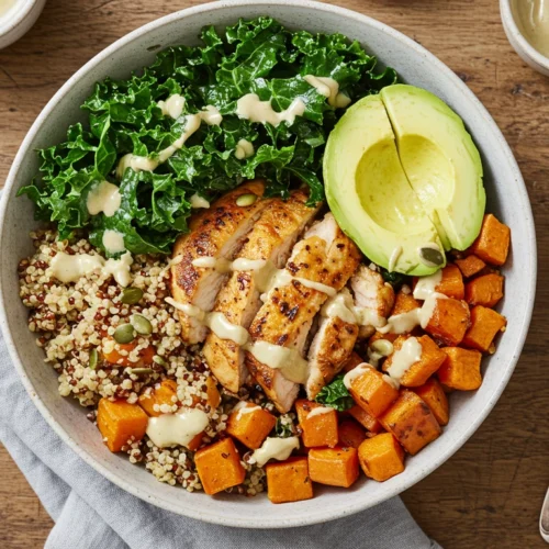 Healthy chicken and sweet potato bowl with quinoa and greens