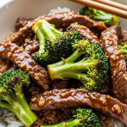 Savory beef and broccoli stir fry with glossy soy-garlic sauce served in a bowl.